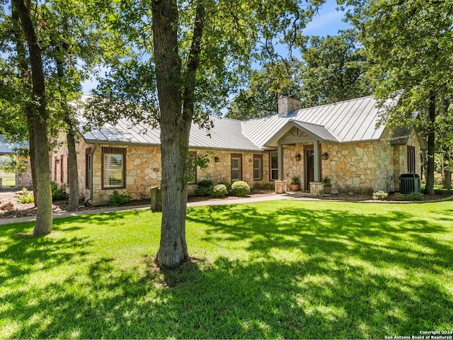 ranch-style home with central AC and a front lawn