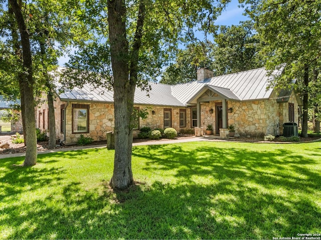 5 Old Fredericksburg, Boerne, TX 78015 - view of front of home with stone siding, central AC unit, a chimney, a standing seam roof, and metal roof