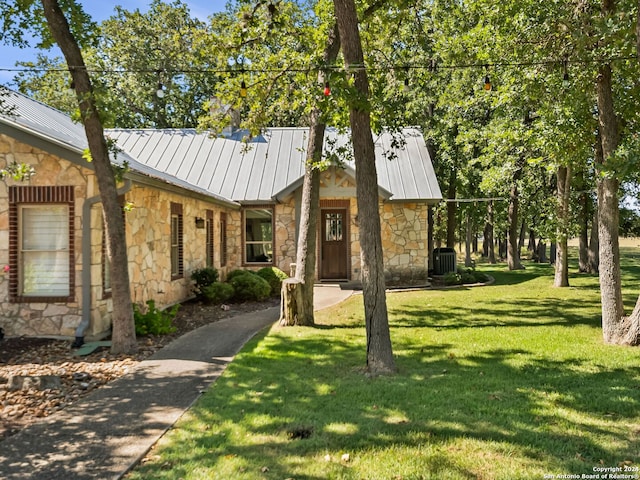 5 Old Fredericksburg, Boerne, TX 78015 - view of front of home with a front lawn, stone siding, a standing seam roof, central AC unit, and metal roof