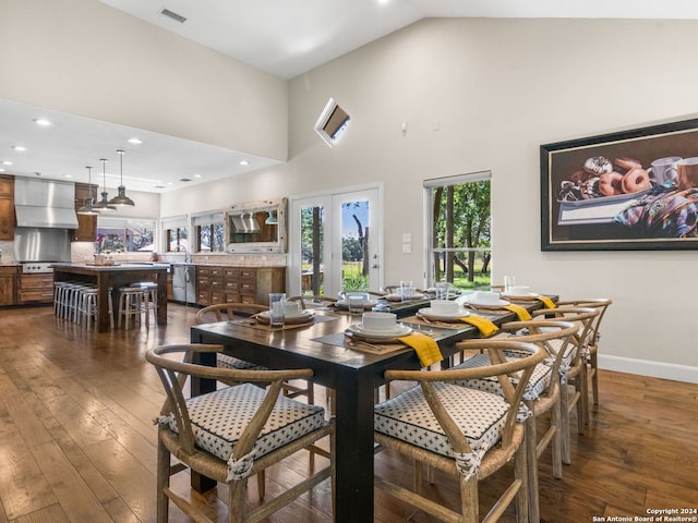 dining room with dark hardwood / wood-style floors, french doors, and high vaulted ceiling