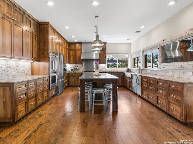 5 Old Fredericksburg, Boerne, TX 78015 - kitchen with appliances with stainless steel finishes, backsplash, dark wood-style flooring, and light stone counters
