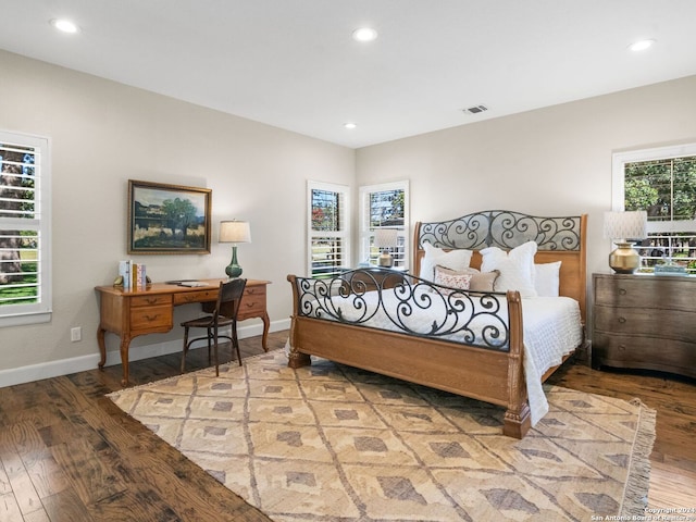 bedroom with light hardwood / wood-style floors and multiple windows