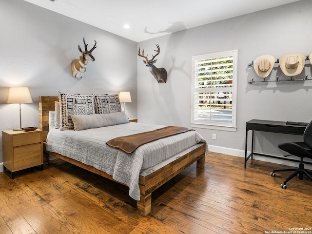 bedroom with hardwood / wood-style floors