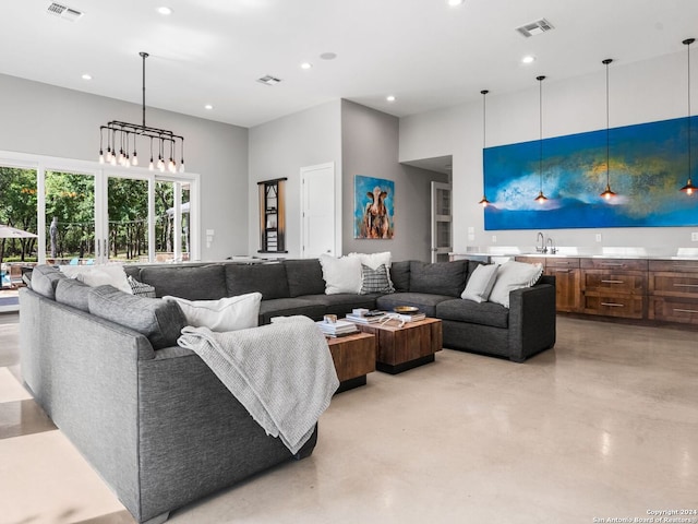 living room with a towering ceiling and sink