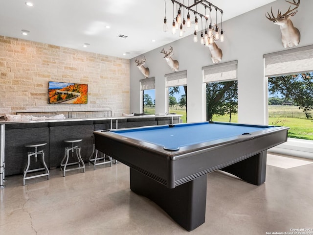 rec room featuring pool table, indoor bar, and a wealth of natural light