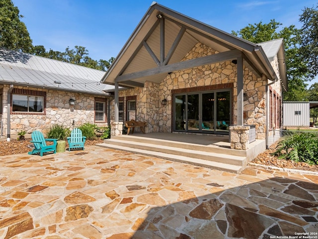 5 Old Fredericksburg, Boerne, TX 78015 - back of property featuring a patio area, stone siding, and metal roof