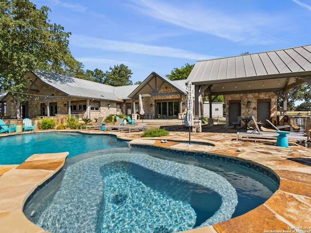 view of pool featuring an in ground hot tub and a patio area