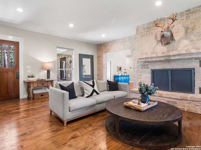 living room with hardwood / wood-style flooring and a fireplace