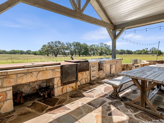 view of patio featuring area for grilling and a gazebo