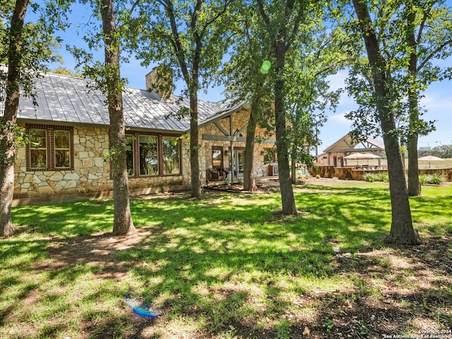5 Old Fredericksburg, Boerne, TX 78015 - back of property featuring a standing seam roof, a chimney, metal roof, a yard, and stone siding