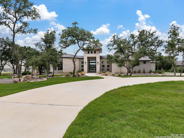 view of front of property with a garage and a front yard