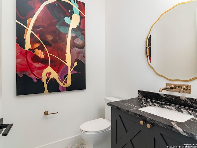 bathroom featuring tile patterned flooring, vanity, and toilet