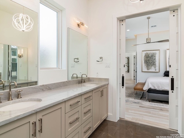 bathroom featuring hardwood / wood-style flooring, vanity, and a chandelier