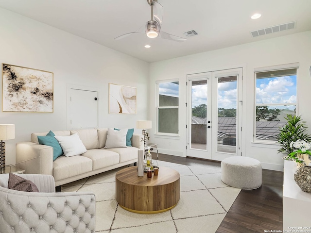 living room featuring ceiling fan, french doors, and light wood-type flooring