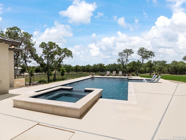 view of swimming pool with an in ground hot tub and a patio