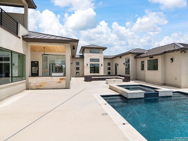 view of pool featuring an in ground hot tub and a patio