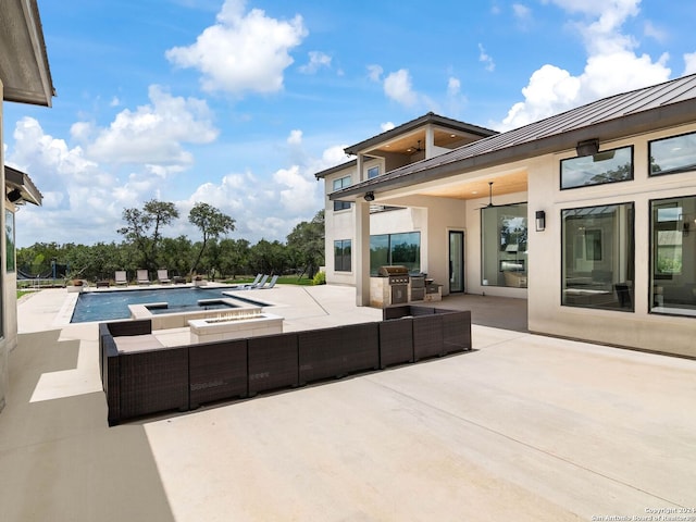 view of swimming pool with an in ground hot tub, outdoor lounge area, a patio area, and grilling area