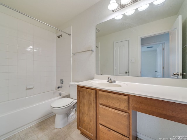 full bathroom with vanity, tiled shower / bath combo, and toilet