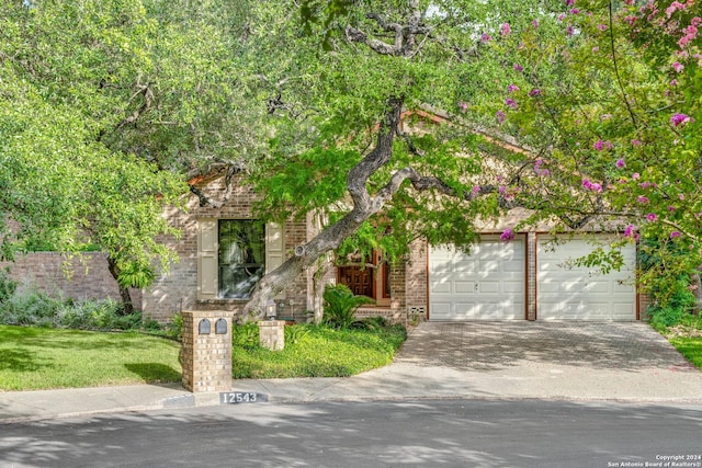 obstructed view of property with a garage