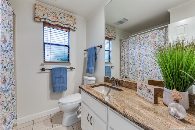 bathroom with toilet, vanity, crown molding, and tile patterned floors