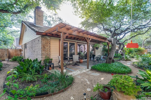 back of house featuring a pergola and a patio