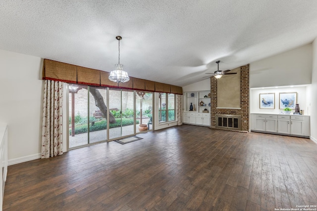 unfurnished living room with lofted ceiling, ceiling fan with notable chandelier, a textured ceiling, and dark hardwood / wood-style floors