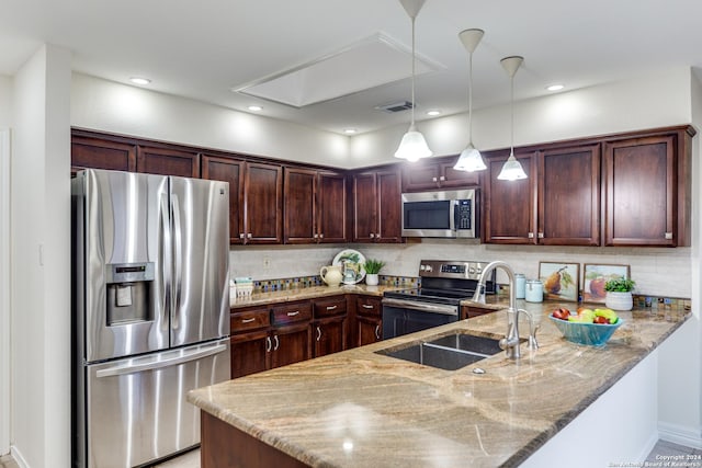 kitchen with kitchen peninsula, light stone countertops, decorative backsplash, appliances with stainless steel finishes, and sink