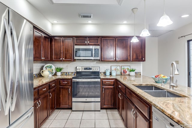 kitchen with stainless steel appliances, hanging light fixtures, light stone countertops, light tile patterned floors, and sink