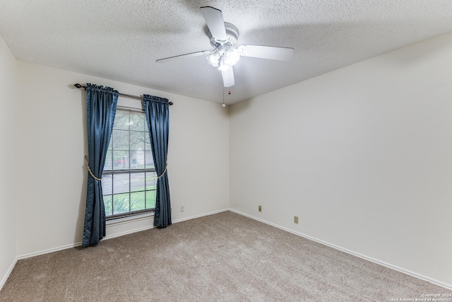 carpeted empty room featuring a textured ceiling and ceiling fan