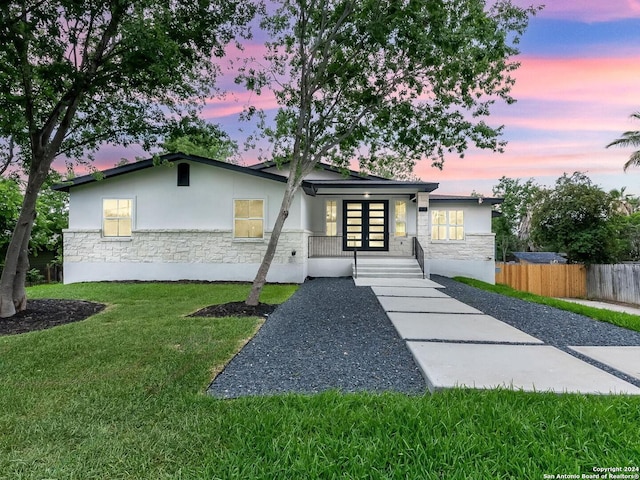 view of front of home featuring a porch and a lawn