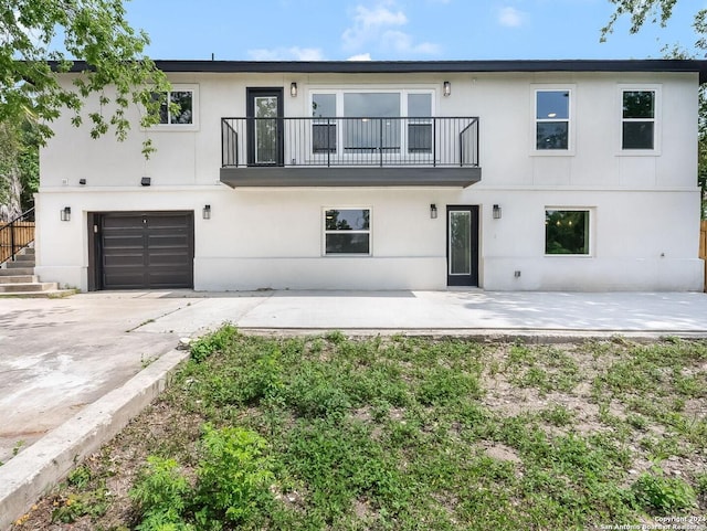 view of front of home featuring a balcony and a garage