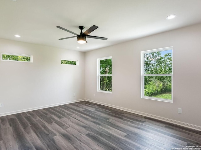 spare room featuring dark hardwood / wood-style floors and ceiling fan