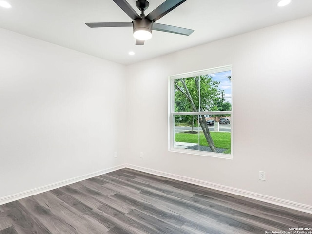 spare room featuring ceiling fan and dark hardwood / wood-style floors