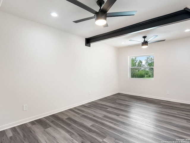 unfurnished room with dark hardwood / wood-style floors, beam ceiling, and ceiling fan