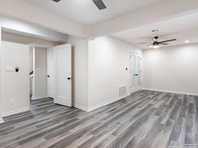 unfurnished room featuring dark wood-type flooring and ceiling fan