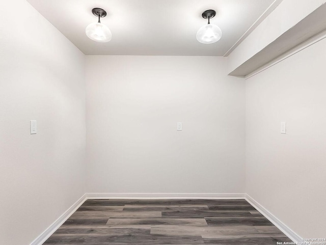 walk in closet with dark wood-type flooring