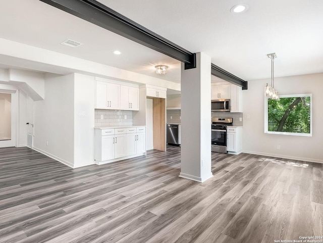 unfurnished living room with light hardwood / wood-style flooring and an inviting chandelier