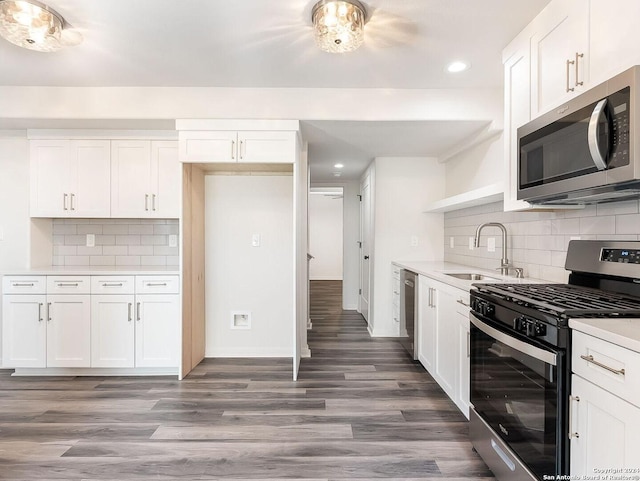 kitchen featuring sink, white cabinetry, appliances with stainless steel finishes, and decorative backsplash