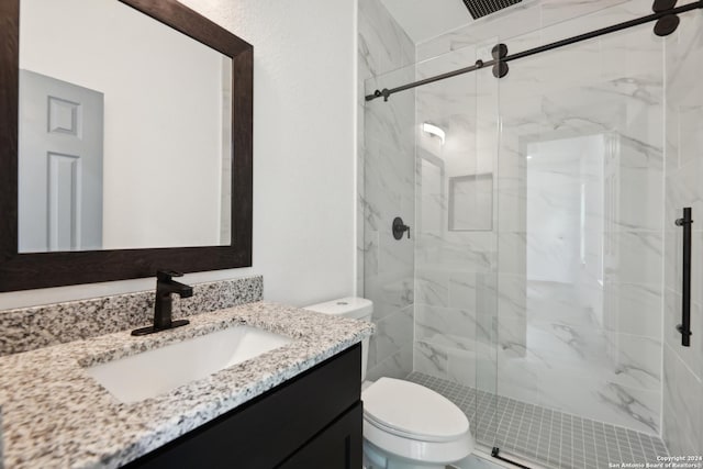 bathroom featuring vanity, an enclosed shower, and toilet