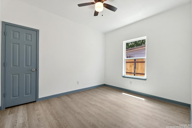 unfurnished room featuring light hardwood / wood-style flooring and ceiling fan