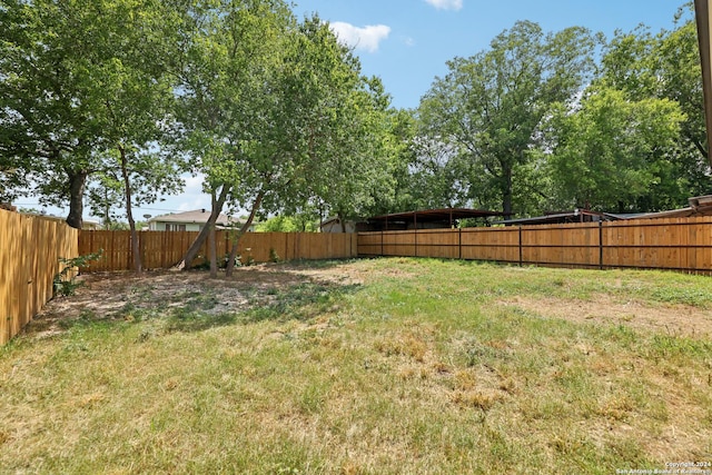 1342 E Chavaneaux Rd, San Antonio, TX 78214 - fenced backyard featuring a carport