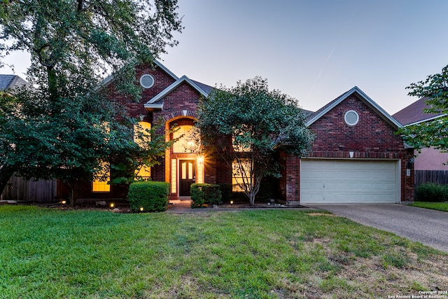 front facade with a yard and a garage