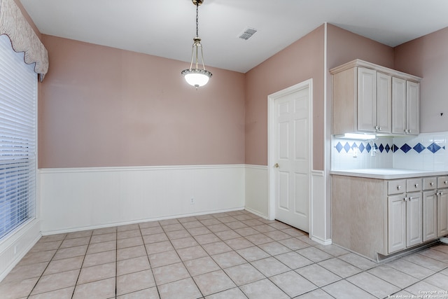 kitchen featuring pendant lighting, light tile patterned floors, and tasteful backsplash