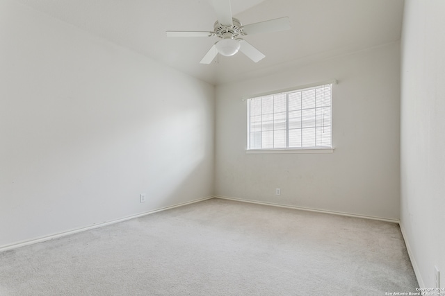 carpeted spare room with ceiling fan