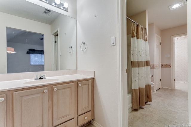 bathroom featuring vanity, shower / tub combo, and tile patterned floors