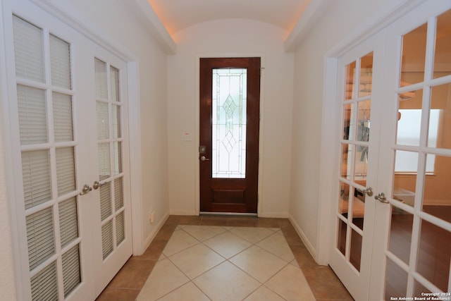 entryway featuring light tile patterned flooring and french doors