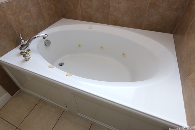 bathroom with a tub and tile patterned floors