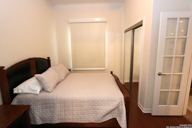 bedroom featuring a closet and dark wood-type flooring