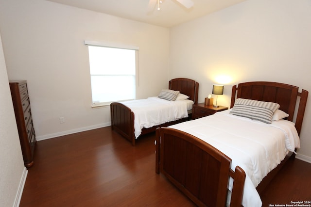 bedroom with dark hardwood / wood-style floors and ceiling fan