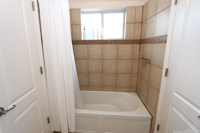 bathroom featuring shower / tub combo with curtain